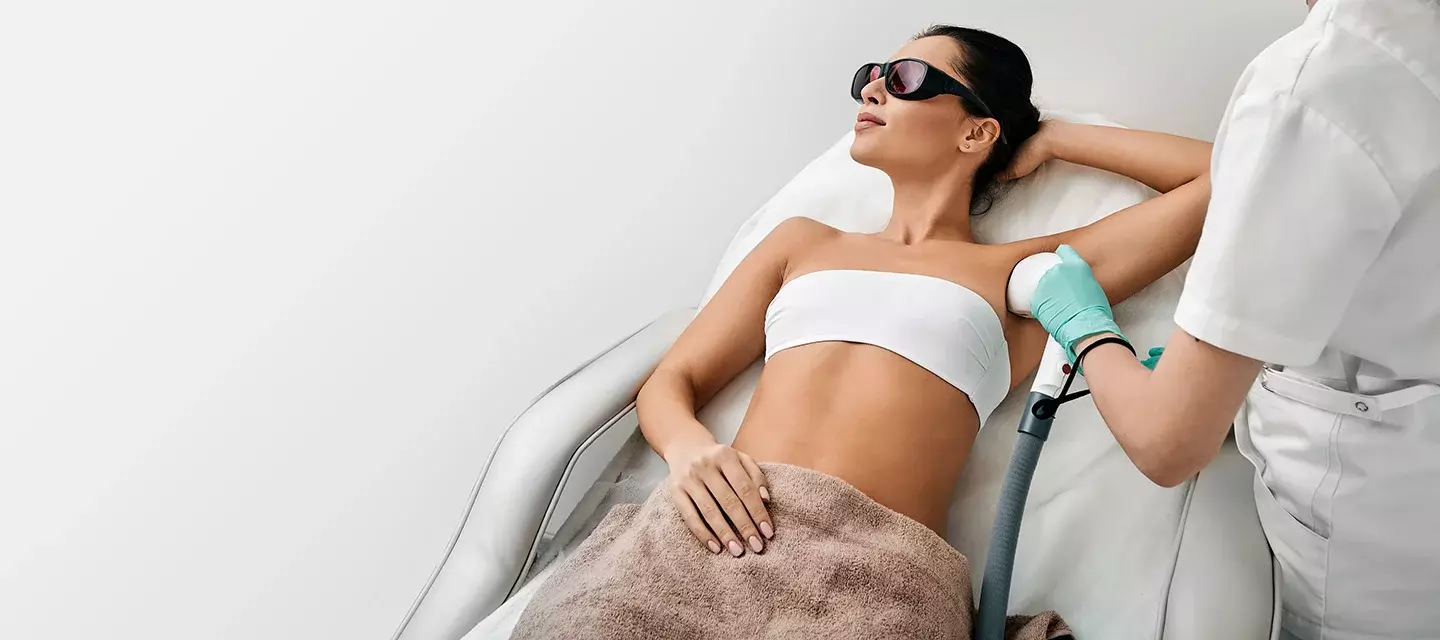 Does laser hair removal hurt A young, fit woman doing laser hair removal on her underarm